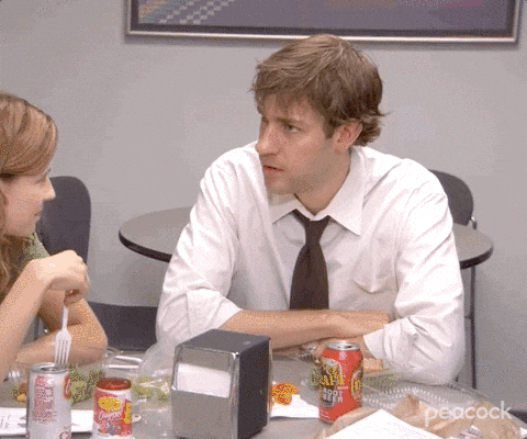 A scene from the TV series The Office where Jim is caught by surprise after a commend. He says, “wait. what?!” as the camera zooms in to emphasize his surprised facial expression.
