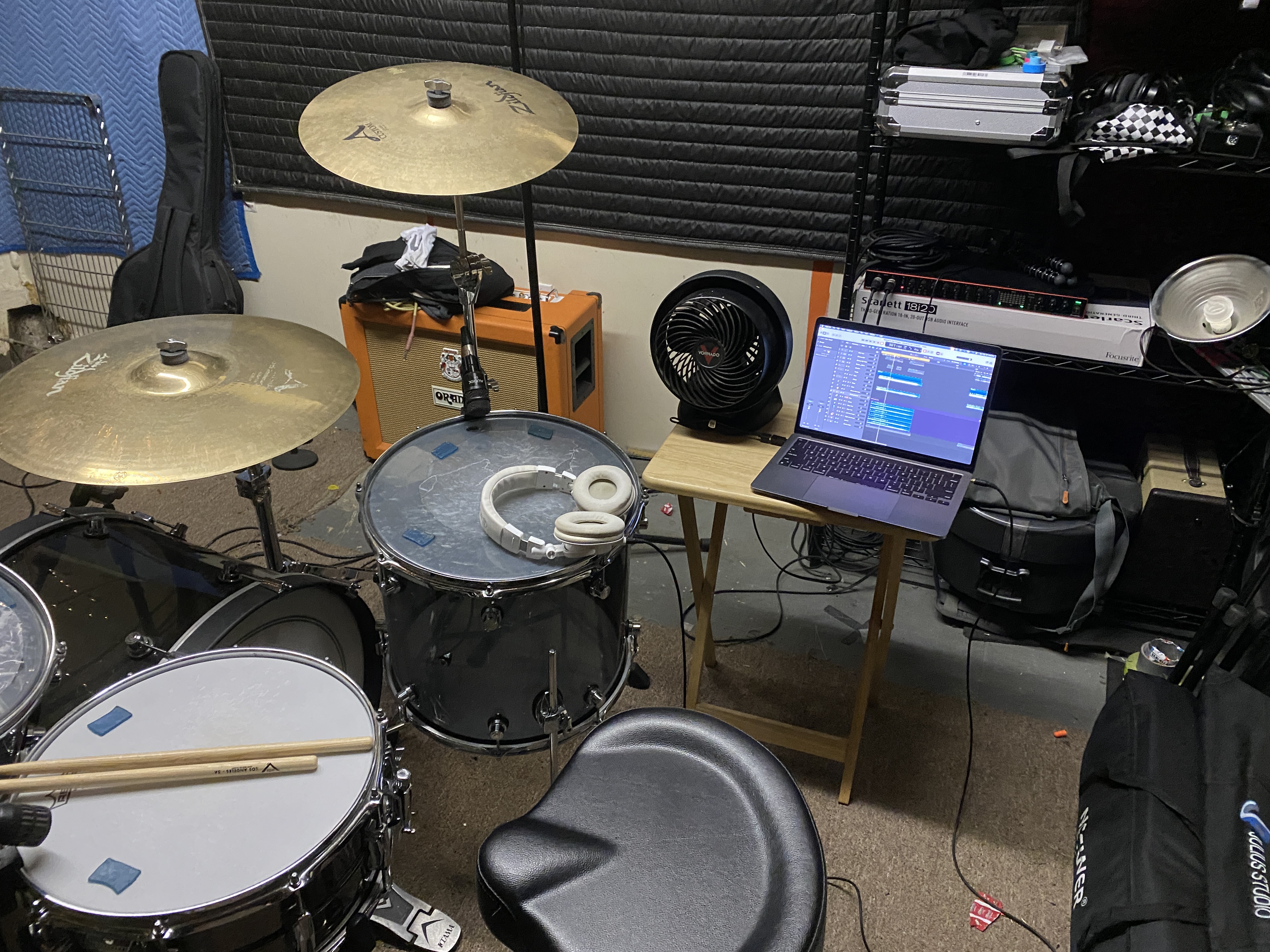 My drum recording setup, which shows my drums with microphones on them and a laptop with recording software running.
